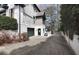 Exterior view of a house with a driveway, a black garage door and a private entrance gate at 1025 Abingdon Ln, Johns Creek, GA 30022