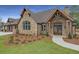Charming exterior with stone and brick, showcasing impeccable curb appeal and architectural detail at 1025 Abingdon Ln, Johns Creek, GA 30022