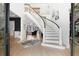 Grand foyer showcasing a curved staircase, hardwood floors, and elegant decor, creating a welcoming entrance at 1025 Abingdon Ln, Johns Creek, GA 30022
