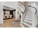 Bright foyer featuring a curved staircase, hardwood floors, and an open view to the dining room at 1025 Abingdon Ln, Johns Creek, GA 30022