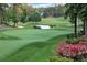 Scenic golf course view with a small pond and lush green grass at 1025 Abingdon Ln, Johns Creek, GA 30022
