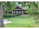View of a beautifully landscaped golf course with mature trees and a sand trap at 1025 Abingdon Ln, Johns Creek, GA 30022