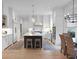 Bright, modern kitchen with white cabinets, stainless steel appliances, a center island, and a cozy dining area at 1025 Abingdon Ln, Johns Creek, GA 30022