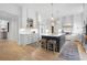 Bright kitchen with white cabinetry, large island, stainless steel appliances, and hardwood floors at 1025 Abingdon Ln, Johns Creek, GA 30022