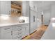 Modern kitchen with white cabinets, quartz countertops, and stainless steel appliances at 1025 Abingdon Ln, Johns Creek, GA 30022