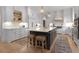 Bright kitchen with white cabinetry, large island, stainless steel appliances, and hardwood floors at 1025 Abingdon Ln, Johns Creek, GA 30022