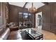 Living room featuring a leather sofa, hardwood floors, and custom wall paneling at 1025 Abingdon Ln, Johns Creek, GA 30022