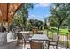 Outdoor seating area overlooking the lush golf course offers a serene space to dine and socialize with nature at 1025 Abingdon Ln, Johns Creek, GA 30022