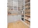 Organized pantry with shelves stocked with storage containers and food at 1025 Abingdon Ln, Johns Creek, GA 30022
