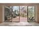 Covered patio featuring a brick floor, outdoor seating, and a view of the landscaped backyard at 1025 Abingdon Ln, Johns Creek, GA 30022
