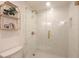 Shower with a glass surround, white and geometric tile, and gold fixtures at 1025 Abingdon Ln, Johns Creek, GA 30022