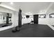 Functional workout room featuring a punching bag, rowing machine, and mirrored walls at 1025 Abingdon Ln, Johns Creek, GA 30022