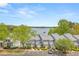 Scenic aerial view of townhomes showcasing lake view, parking, and lush greenery for a tranquil living environment at 2300 Habersham Marina Rd # 201, Cumming, GA 30041