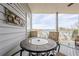 Balcony with outdoor table and seating offering views of the lake at 2300 Habersham Marina Rd # 201, Cumming, GA 30041