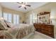 Bedroom featuring ceiling fan, natural light, and large wooden dresser with ornate mirror at 2300 Habersham Marina Rd # 201, Cumming, GA 30041