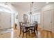Bright dining area featuring hardwood floors, a chandelier, and ample natural light from shuttered windows at 2300 Habersham Marina Rd # 201, Cumming, GA 30041