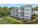 Three-story condo complex featuring screened porches and open deck spaces, surrounded by trees at 2300 Habersham Marina Rd # 201, Cumming, GA 30041