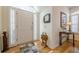 Welcoming foyer with hardwood floors, a decorative mirror, and ample natural light streaming through the windows at 2300 Habersham Marina Rd # 201, Cumming, GA 30041