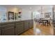 Eat-in kitchen with wood floors, view to the dining and living room, and granite counters at 2300 Habersham Marina Rd # 201, Cumming, GA 30041