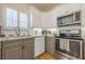 Updated kitchen with stainless steel appliances, white upper cabinets, and granite countertops at 2300 Habersham Marina Rd # 201, Cumming, GA 30041