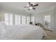 Bright bedroom with plantation shutters, leading to a door to a screened-in lanai at 2300 Habersham Marina Rd # 201, Cumming, GA 30041