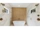 Luxurious bathroom features a freestanding tub, dual shower heads and marble walls at 295 Pebble Trl, Alpharetta, GA 30009