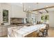 Bright kitchen featuring a large island with quartz countertop and stainless steel appliances at 295 Pebble Trl, Alpharetta, GA 30009