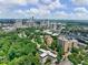 Breathtaking aerial view capturing the city skyline surrounded by lush greenery of the neighborhood at 2965 Pharr Court South Nw # 102, Atlanta, GA 30305
