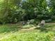 Serene backyard with stone benches, a birdbath, and lush greenery providing shade at 2965 Pharr Court South Nw # 102, Atlanta, GA 30305