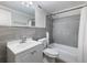 Modern bathroom featuring grey tile, updated fixtures, and a shower-tub combo at 2965 Pharr Court South Nw # 102, Atlanta, GA 30305