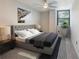 Comfortable bedroom featuring a tufted headboard and a light-filled window at 2965 Pharr Court South Nw # 102, Atlanta, GA 30305