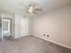 Carpeted bedroom with a door leading to a bathroom and a ceiling fan at 2965 Pharr Court South Nw # 102, Atlanta, GA 30305