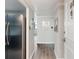 Inviting hallway with modern gray walls and trim, leading to a stainless steel refrigerator and a view of a window at 2965 Pharr Court South Nw # 102, Atlanta, GA 30305