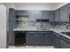 Chic kitchen featuring gray cabinets, granite counters, a tiled backsplash, and a black dishwasher for modern living at 2965 Pharr Court South Nw # 102, Atlanta, GA 30305