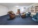 Common area with a cozy seating arrangement, piano, and bookshelf at 2965 Pharr Court South Nw # 102, Atlanta, GA 30305