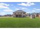 View of the home's backyard featuring a lush green lawn, a storage shed, and a screened in porch at 701 Cupcake Ct, Mcdonough, GA 30252