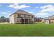 A home's backyard features a covered patio and large green lawn at 701 Cupcake Ct, Mcdonough, GA 30252
