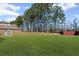 The backyard boasts a sprawling lawn and a storage shed, with mature trees providing privacy at 701 Cupcake Ct, Mcdonough, GA 30252