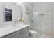 Stylish bathroom featuring a shower with glass door, and vanity with gray cabinets at 701 Cupcake Ct, Mcdonough, GA 30252