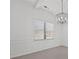 Refined dining space featuring a stylish chandelier, classic wainscoting, and bright natural light at 701 Cupcake Ct, Mcdonough, GA 30252