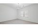 Bright, airy room featuring a modern chandelier, white walls, and large window for ample natural light at 701 Cupcake Ct, Mcdonough, GA 30252