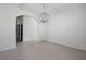 Elegant dining room with a stylish chandelier, wainscoting, and an arched entryway to another room at 701 Cupcake Ct, Mcdonough, GA 30252