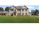Stunning two-story home with a brick facade, lush lawn, and meticulously landscaped front yard at 701 Cupcake Ct, Mcdonough, GA 30252