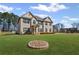Gorgeous home with lush green lawn and a unique stone-lined flower bed adding charm to the property at 701 Cupcake Ct, Mcdonough, GA 30252