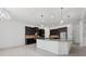 Elegant kitchen featuring dark cabinetry, a center island with granite countertops, and modern pendant lights at 701 Cupcake Ct, Mcdonough, GA 30252