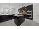 Modern kitchen featuring dark cabinetry, granite countertops, stainless steel appliances, and pendant lighting at 701 Cupcake Ct, Mcdonough, GA 30252