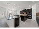 Beautiful kitchen with a large island, dark cabinetry, granite countertops, and stainless steel appliances at 701 Cupcake Ct, Mcdonough, GA 30252