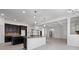 Gourmet kitchen with granite countertops, dark wood cabinetry, a large island, and stylish pendant lighting at 701 Cupcake Ct, Mcdonough, GA 30252