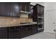 Modern kitchen with dark cabinetry, stainless steel appliances, and granite countertops at 701 Cupcake Ct, Mcdonough, GA 30252