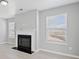 Cozy living room featuring a fireplace, windows, and light gray walls at 701 Cupcake Ct, Mcdonough, GA 30252